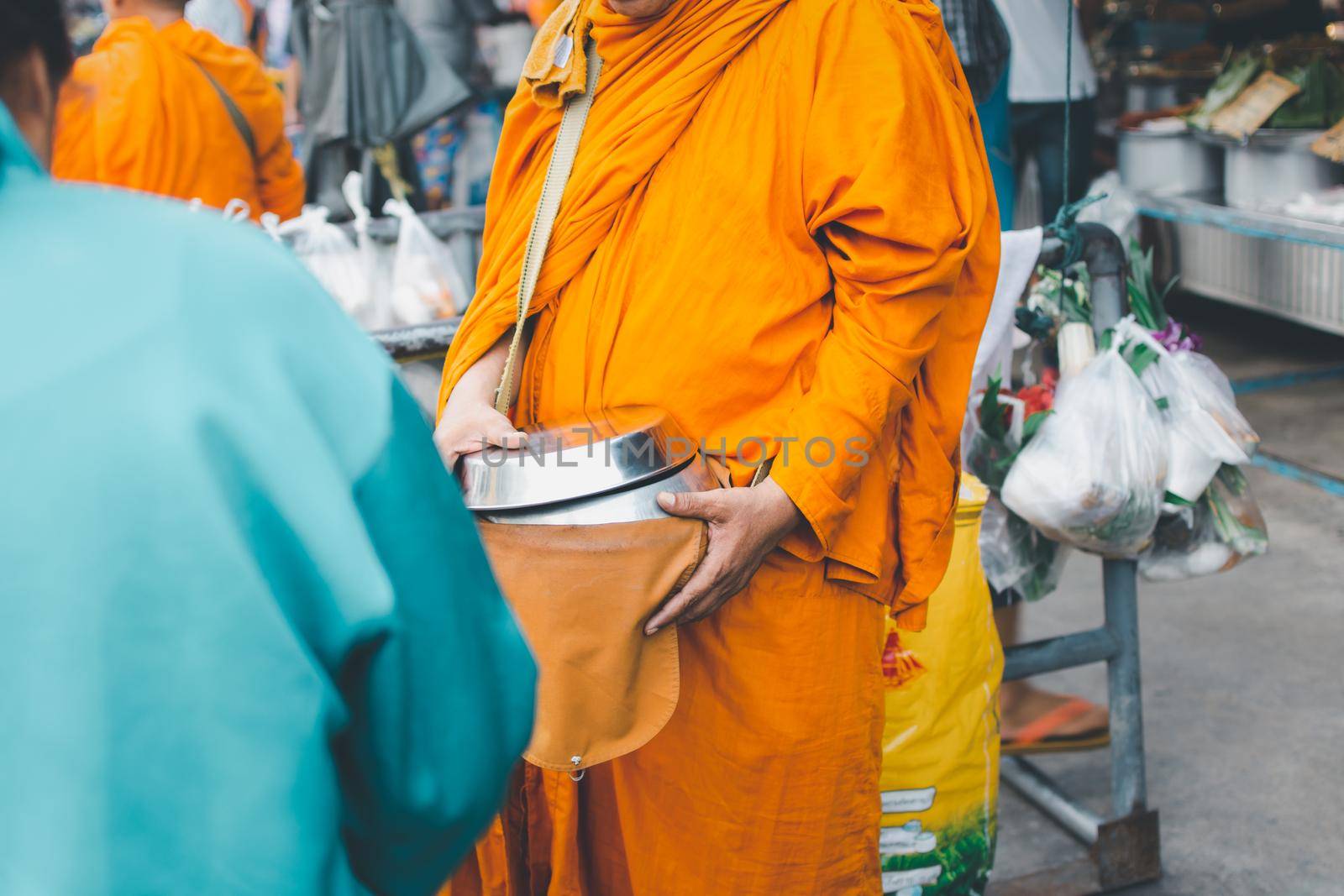 Thai monk ask for alms in morning for buddhist to make merit to offer food to the monks and receive blessing from the monks
