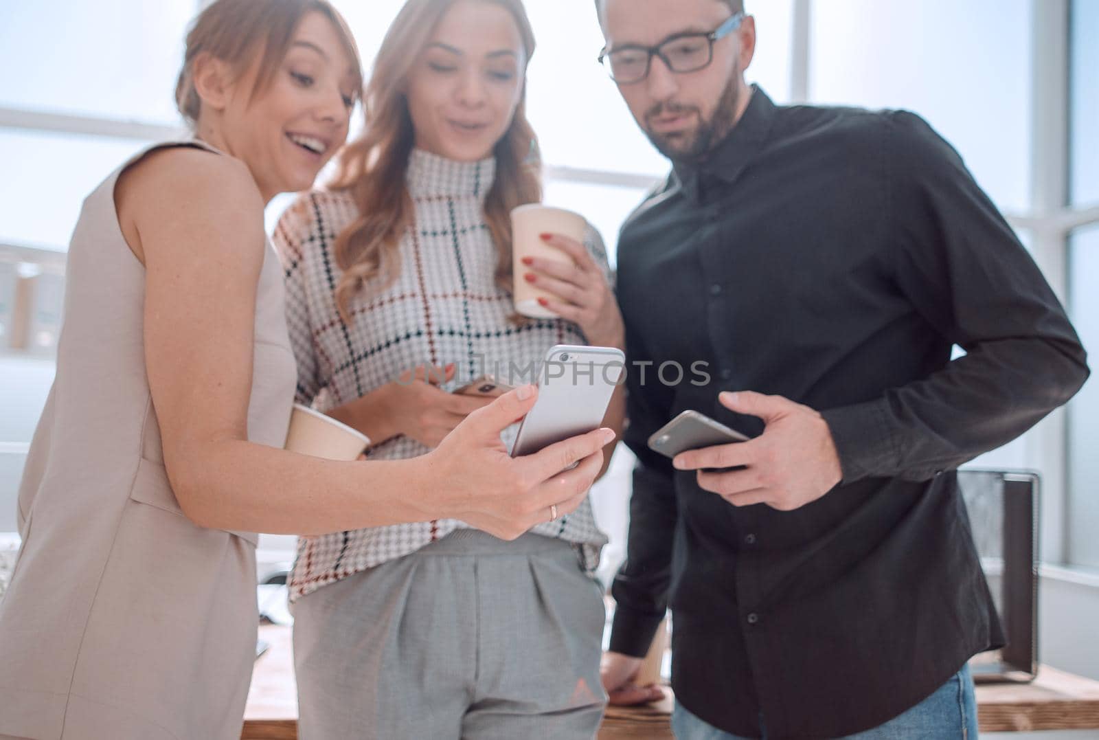 business team reading emails on their smartphones. people and technology