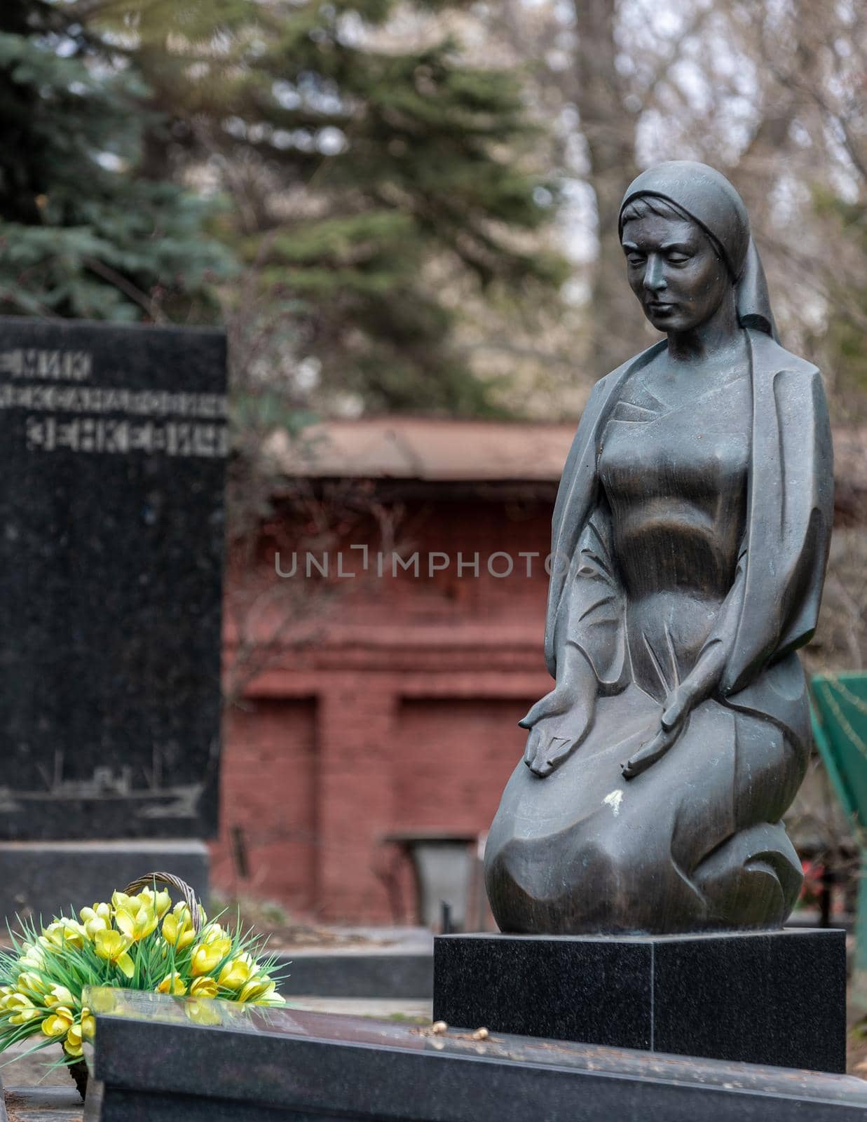 Moscow Russia - april 17 2022: Stone statue of a woman on a grave at the Novodevichy Cemetery. High quality photo