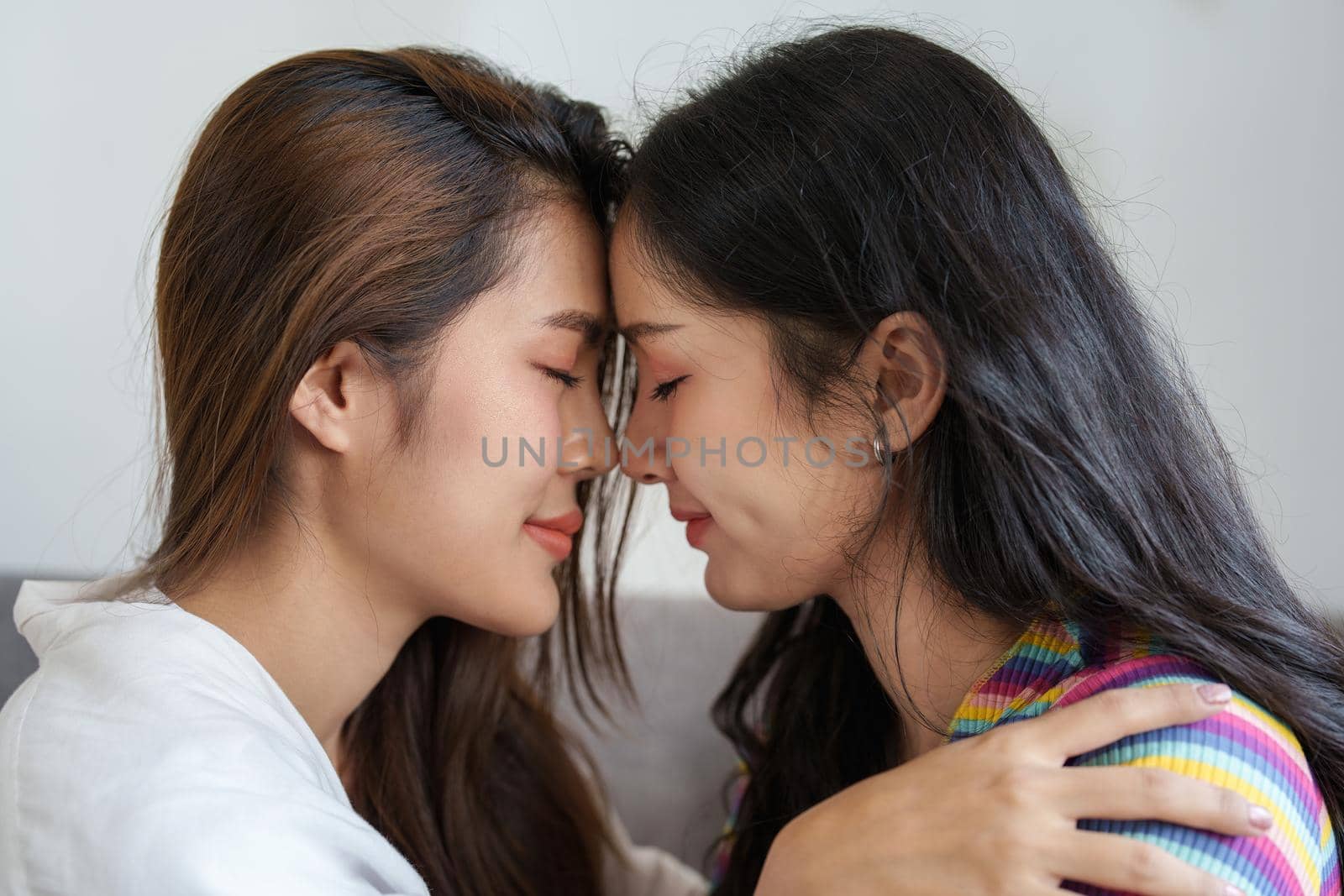 lgbtq, lgbt concept, homosexuality, portrait of two Asian women posing happy together and showing love for each other while being together by Manastrong