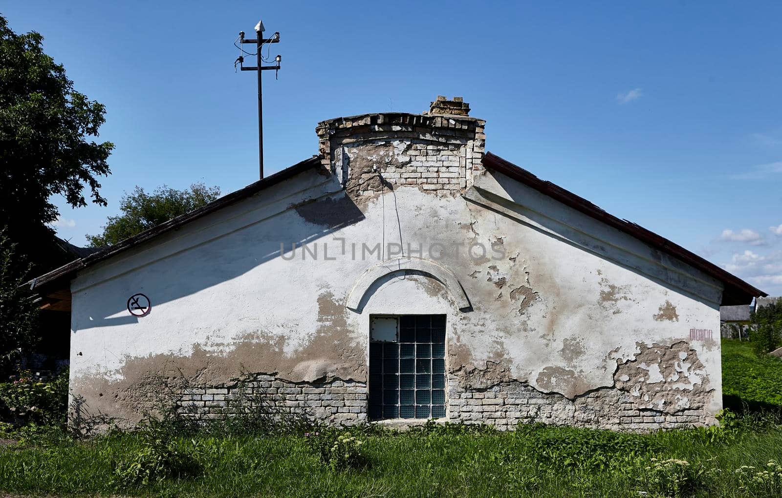 An old abandoned wine cellar with whitewash. The facade of the building is overground part.