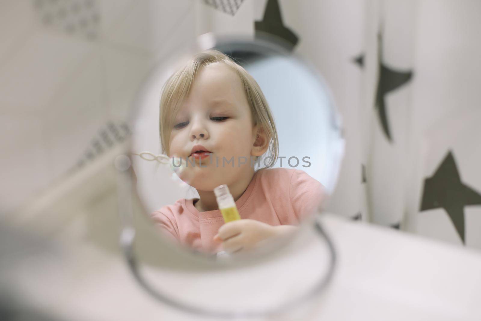 portrait of a cute baby girl playing with water and soap bubbles in a bath sink at home by paralisart