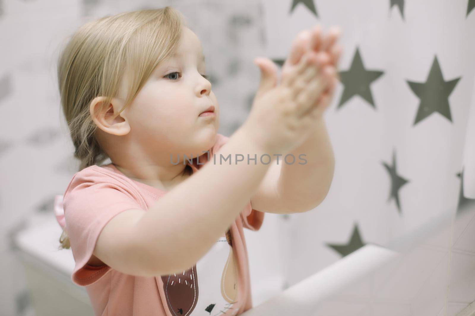 Little toddler girl in bathroom washing hands. Healthy, Child Hygiene concept. by paralisart