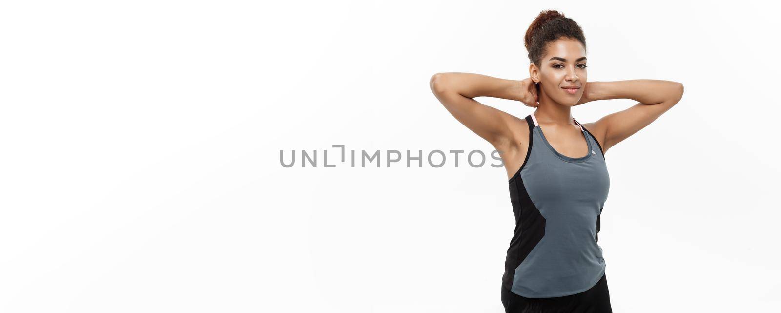 Healthy and Fitness concept - portrait of African American girl posing with fitness clothes over white studio.