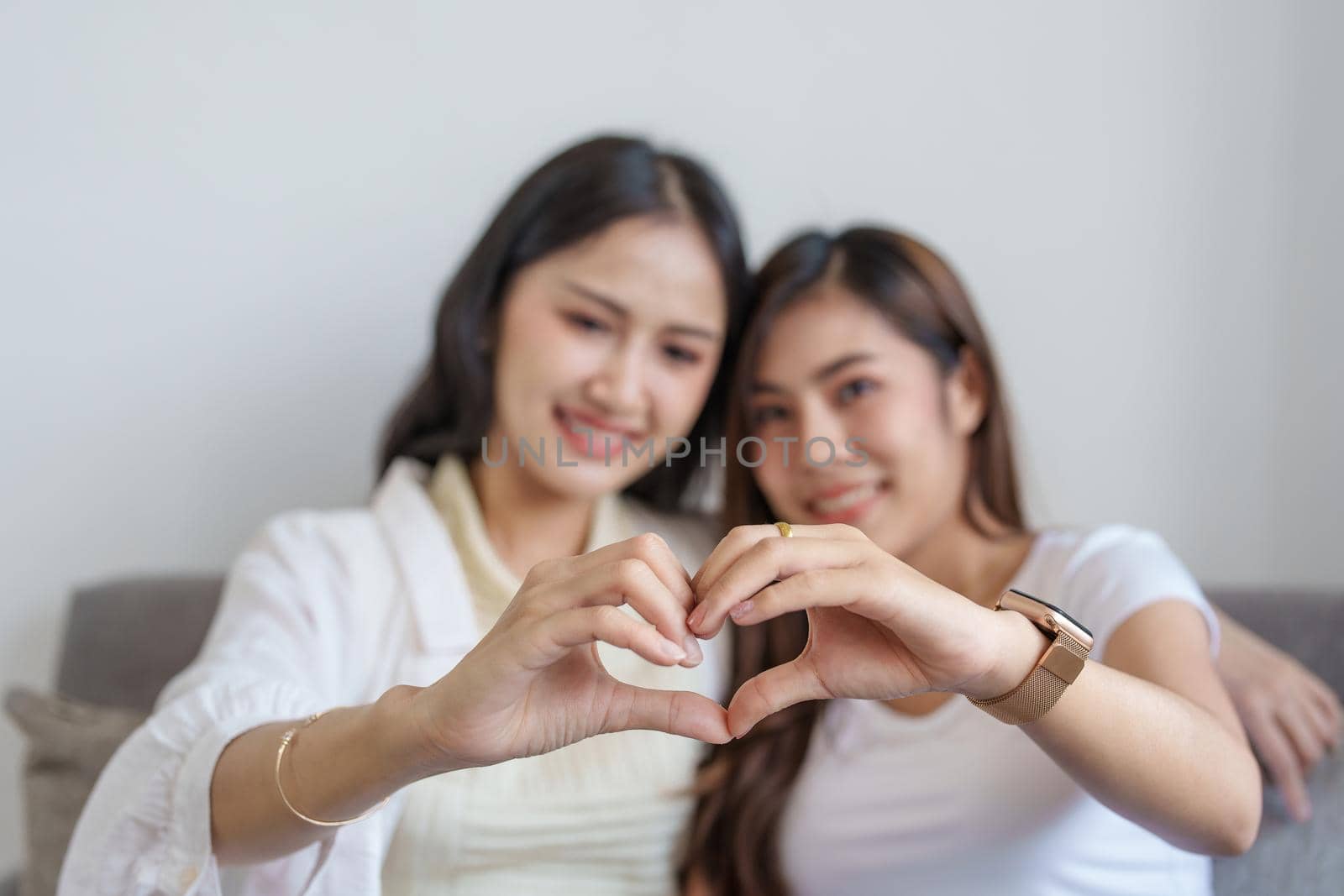 lgbtq, lgbt concept, homosexuality, two Asian women posing happy together and showing love for each other while being together by Manastrong