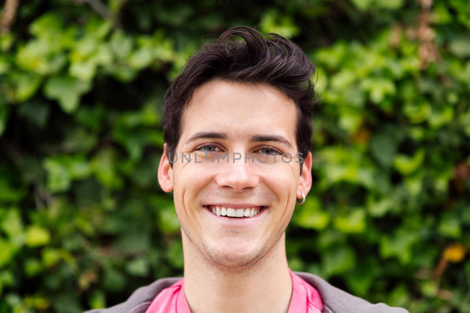 horizontal portrait of a handsome young man smiling, concept of happiness and teenager lifestyle