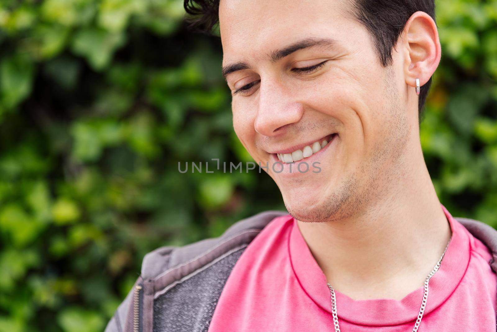 portrait of a happy young man smiling, concept of happiness and teenager lifestyle, copy space for text