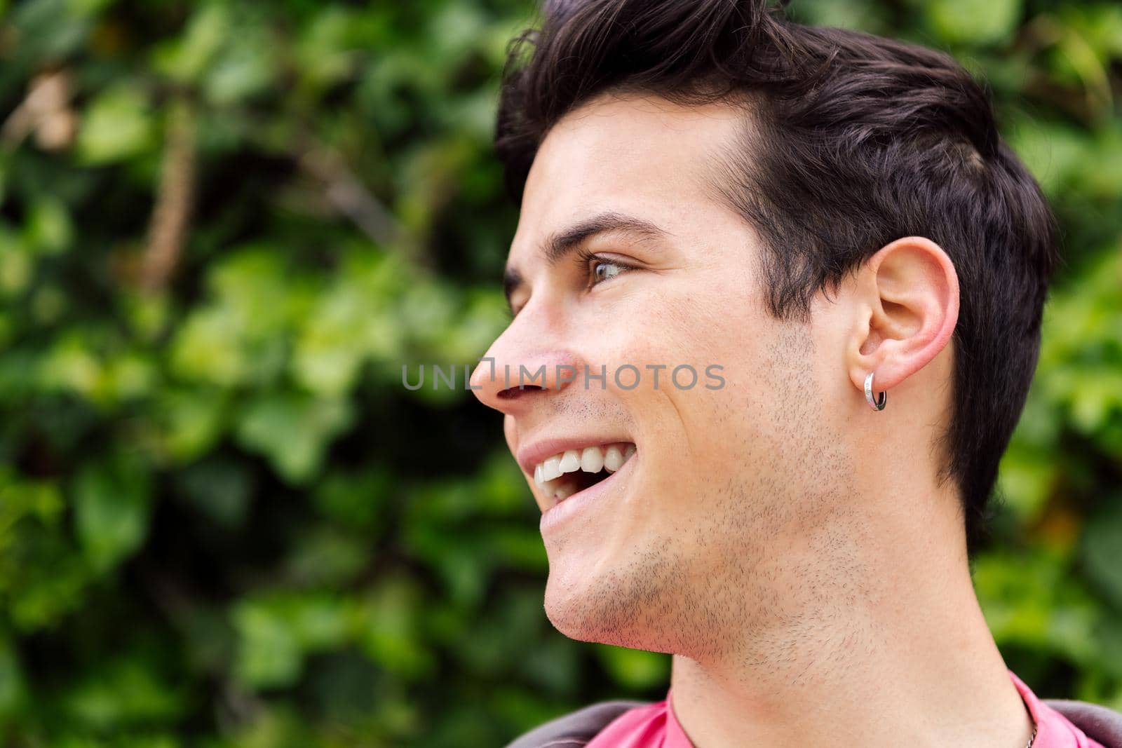 portrait of a cheerful young man smiling, concept of happiness and teenager lifestyle, copy space for text