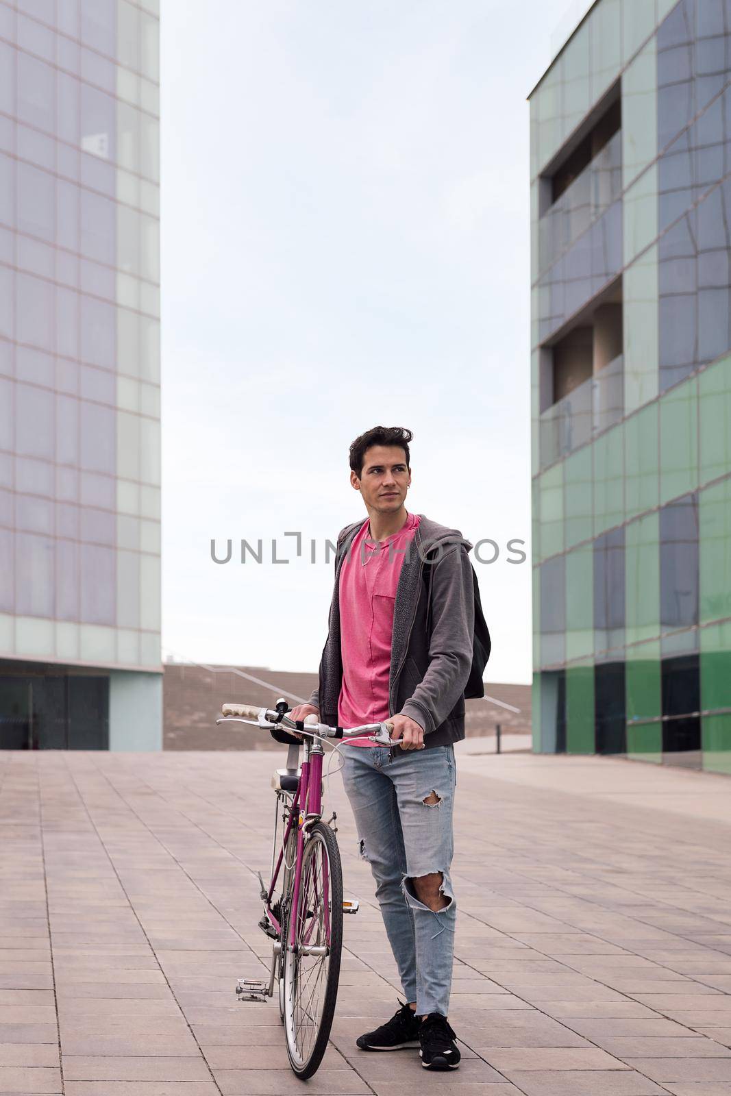 vertical photo of a young man holding a retro bike by raulmelldo