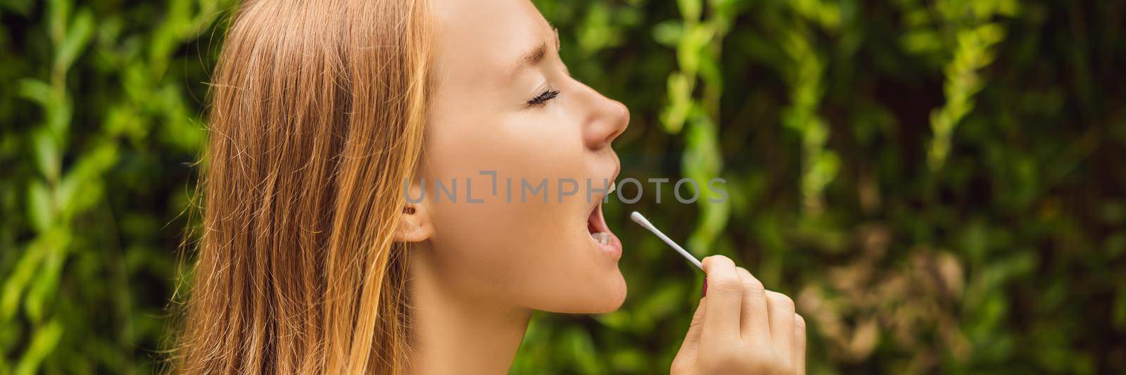 Woman doing DNA test with cotton swab. Test for home use BANNER, LONG FORMAT by galitskaya