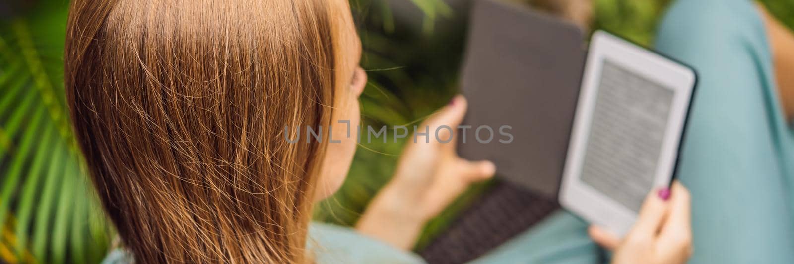 Woman reads e-book on deck chair in the garden. BANNER, LONG FORMAT