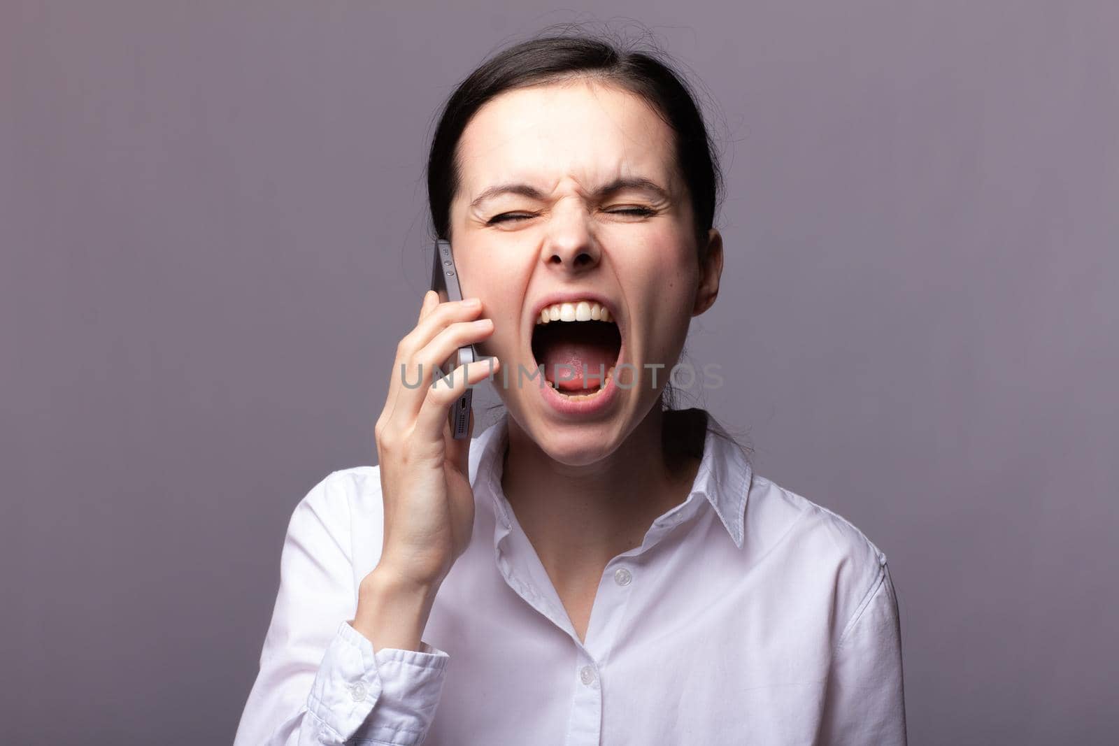 woman in a white shirt communicates on the phone by shilovskaya