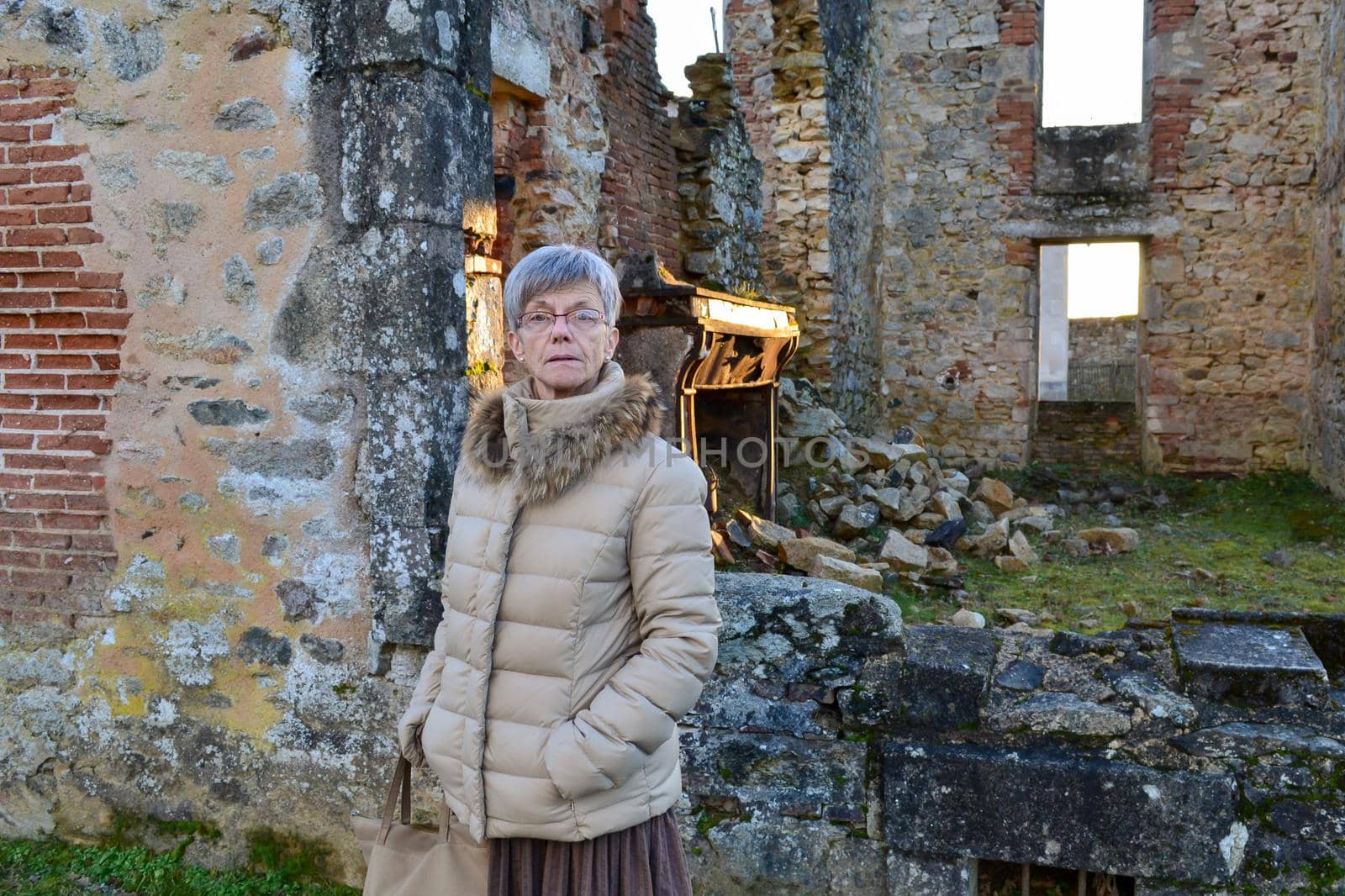A woman near destroyed building during World War 2 in Oradour sur Glane France