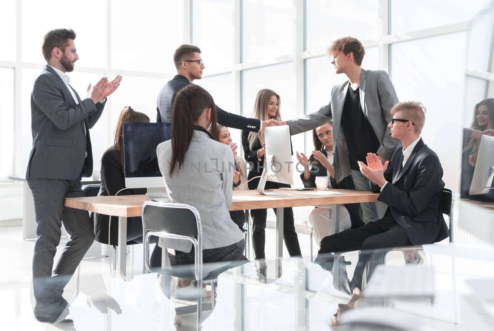 Manager shaking hands with an employee during a work meeting. success concept