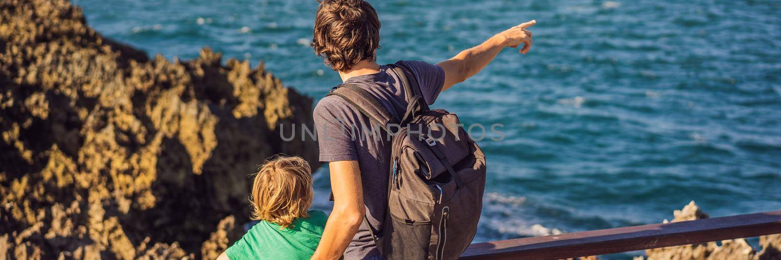 Father and son travelers on amazing Nusadua, Waterbloom Fountain, Bali Island Indonesia. Traveling with kids concept. BANNER, LONG FORMAT