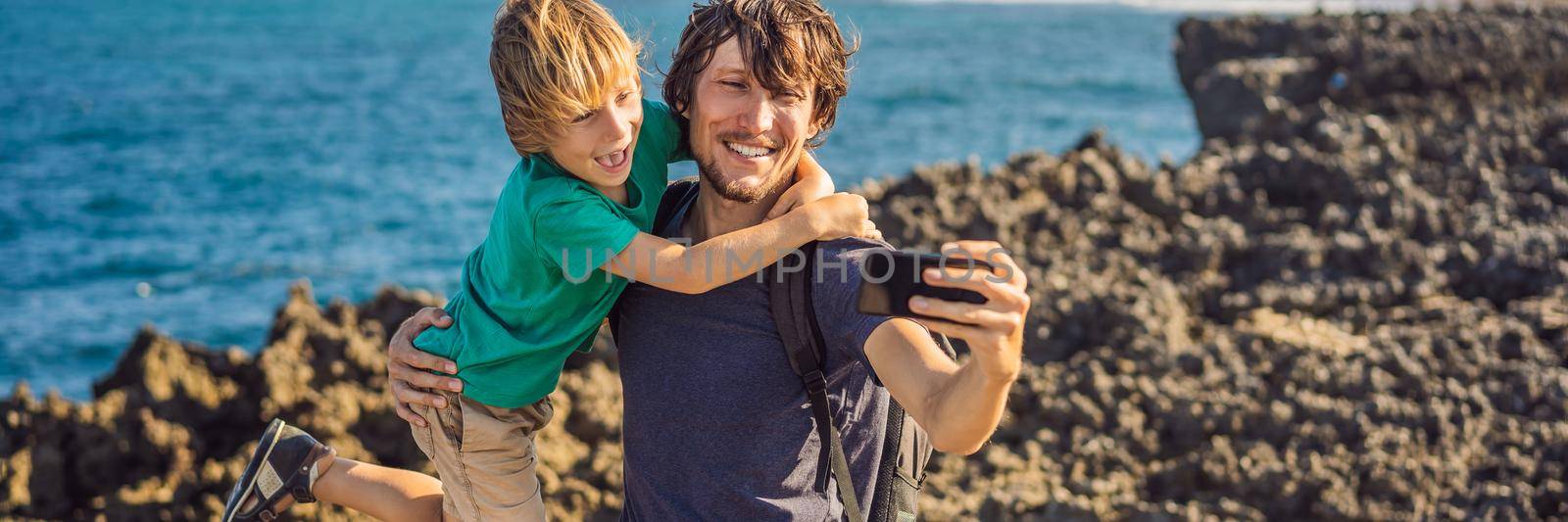 Father and son travelers on amazing Nusadua, Waterbloom Fountain, Bali Island Indonesia. Traveling with kids concept BANNER, LONG FORMAT by galitskaya