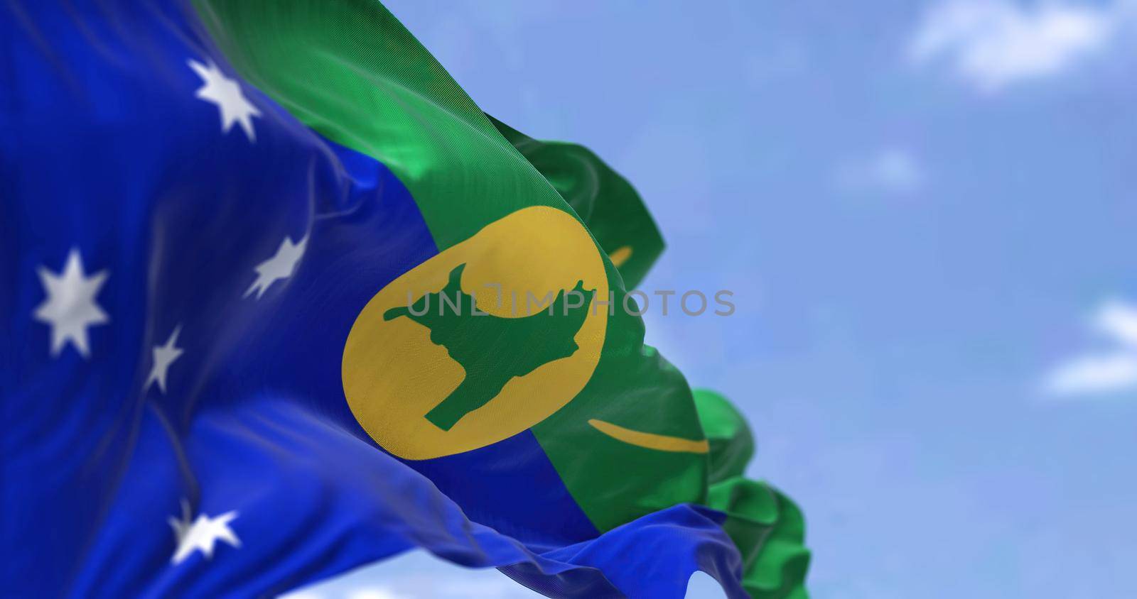 Flag of Christmas Island waving in the wind on a clear day. Christmas Island is an Australian external territory comprising the island of the same name. It is located in the Indian Ocean