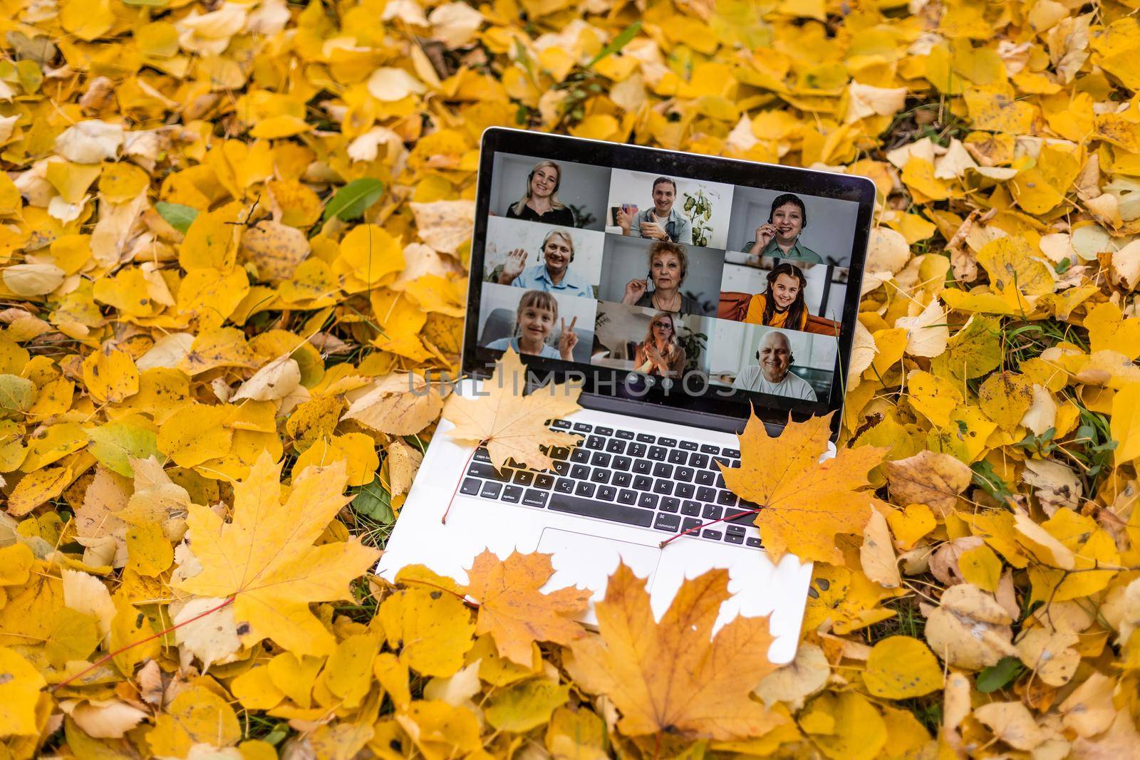laptop with a screen is lying on a on the background of the autumn park.