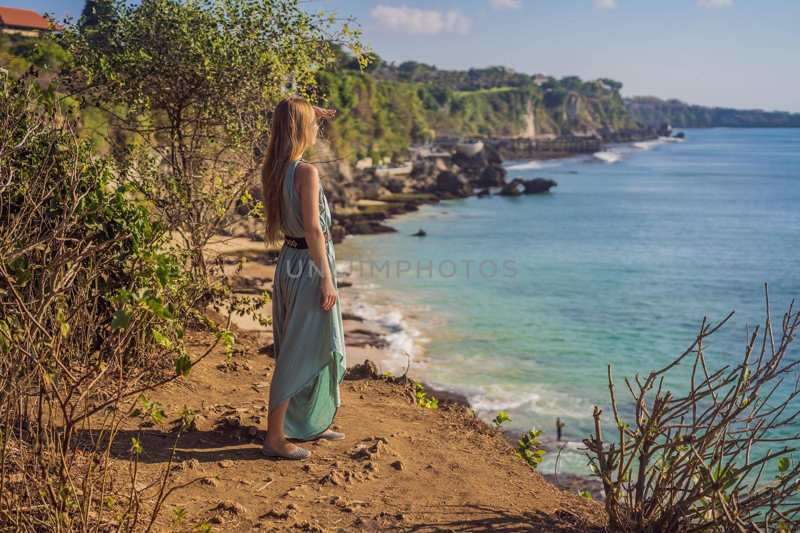 Young woman tourist on Pantai Tegal Wangi Beach, Bali Island, Indonesia. Bali Travel Concept by galitskaya