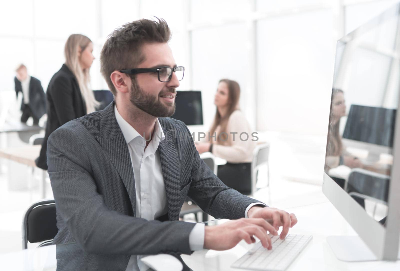 young businessman working on an office computer. people and technology