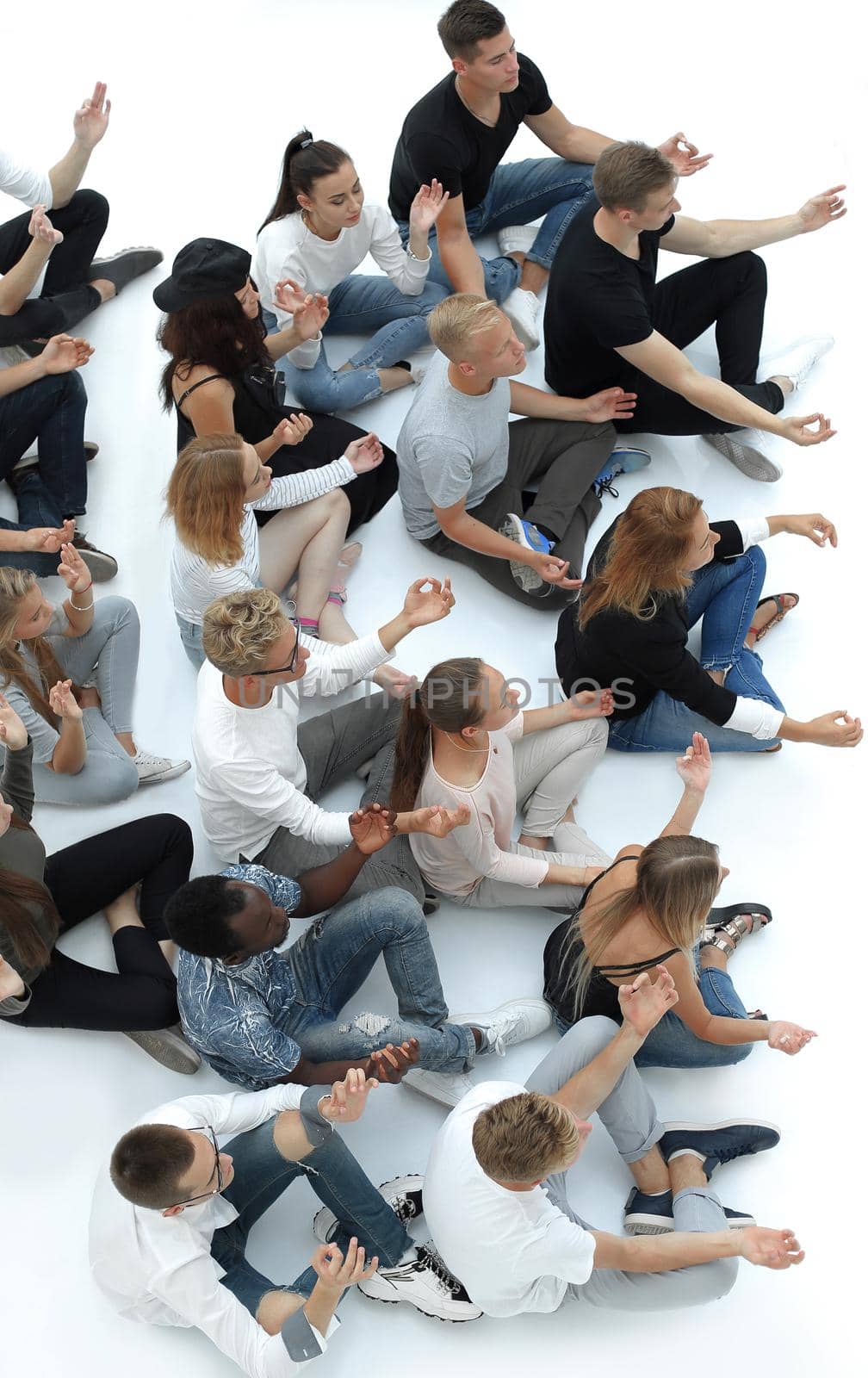 top view. casual group of young people meditating sitting on the floor.