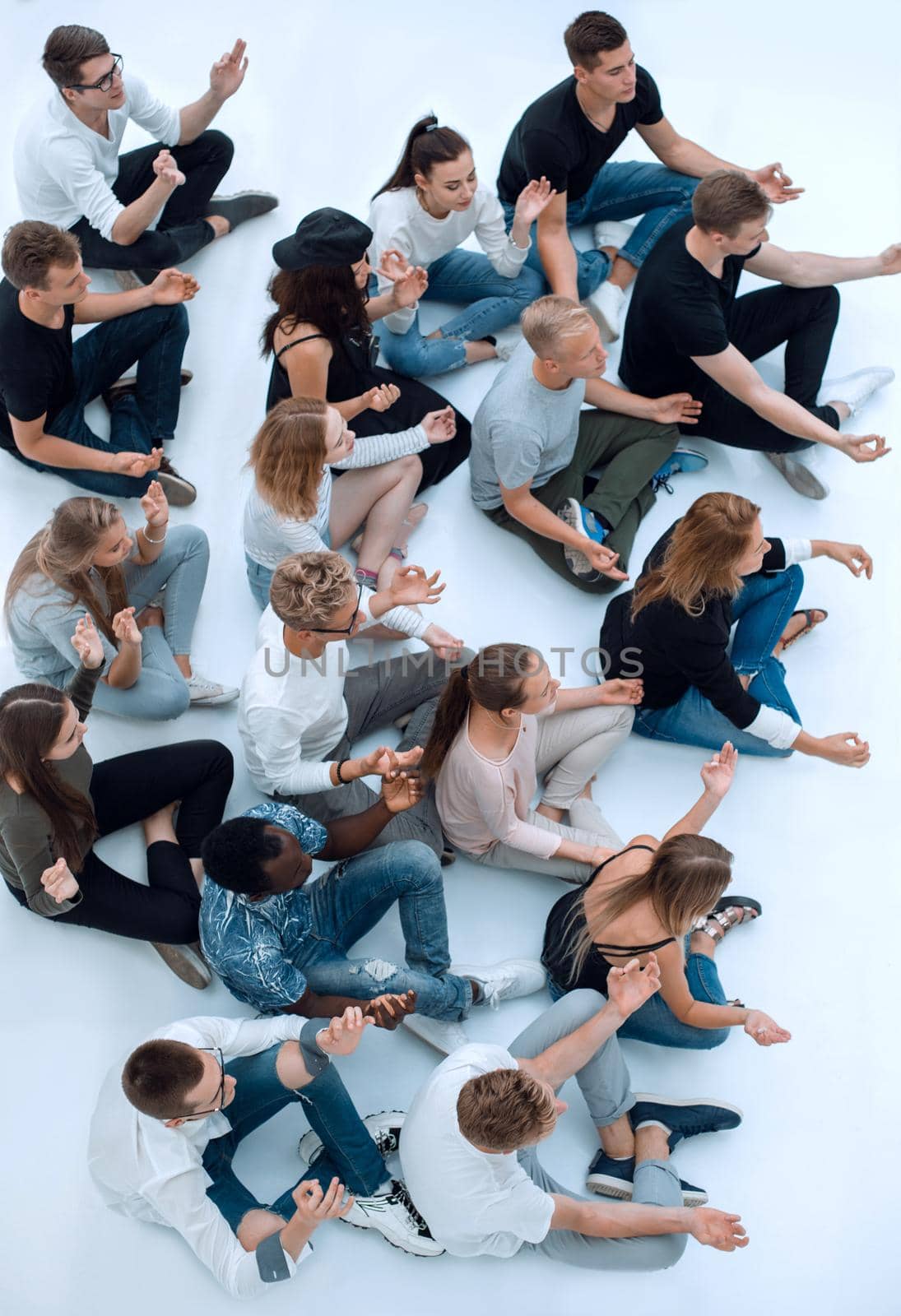 top view. casual group of young people meditating sitting on the floor.