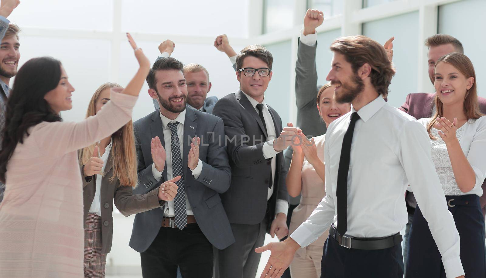 corporate group of employees congratulating each other on the victory . the concept of teamwork