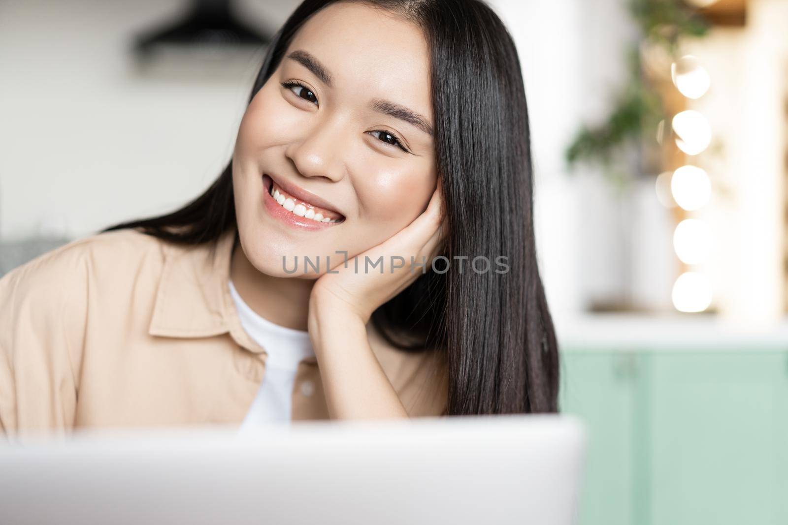Portrait of smiling asian student, girl using computer, working on laptop or studying online by Benzoix