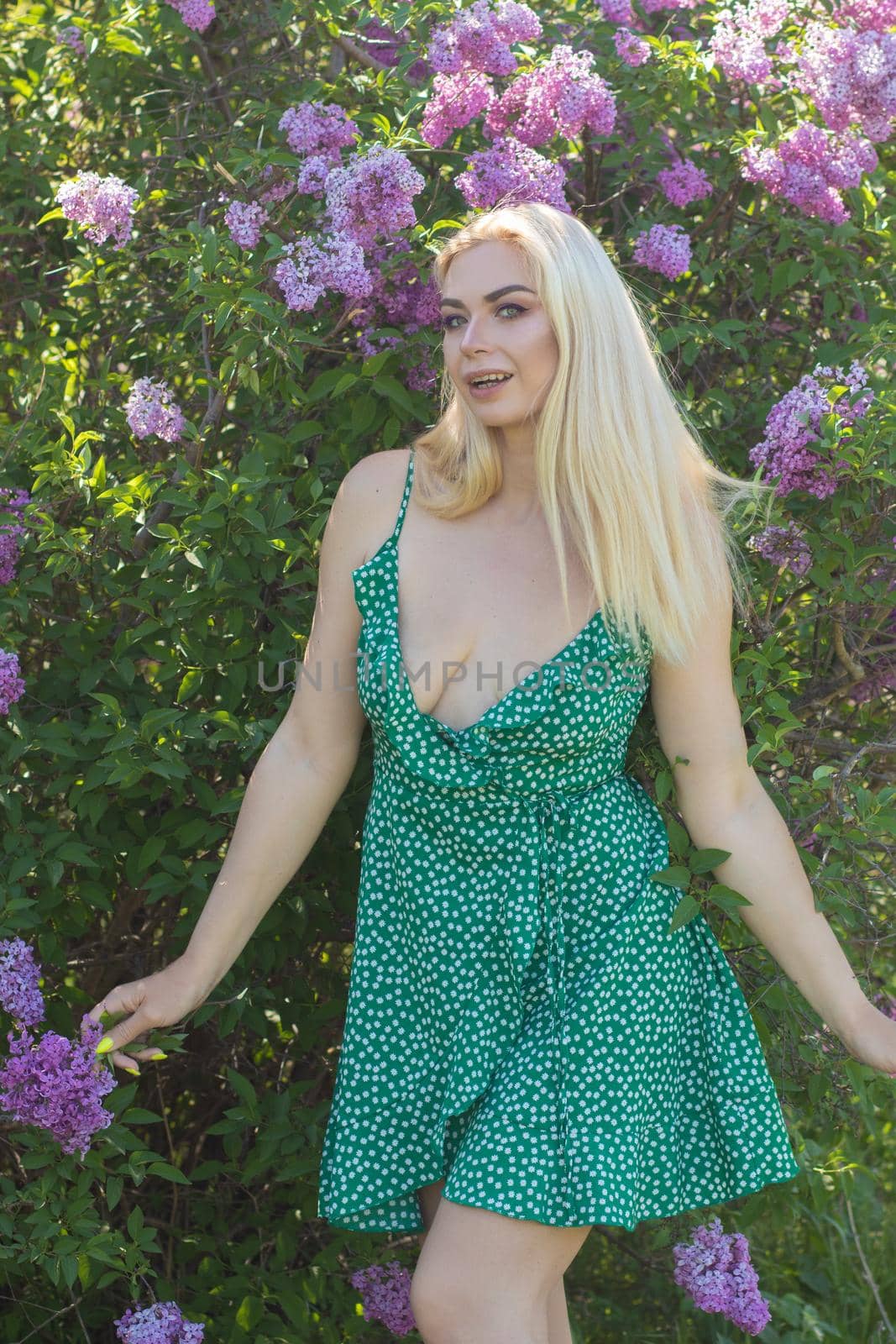 Blonde woman near lilac bush by Bonda