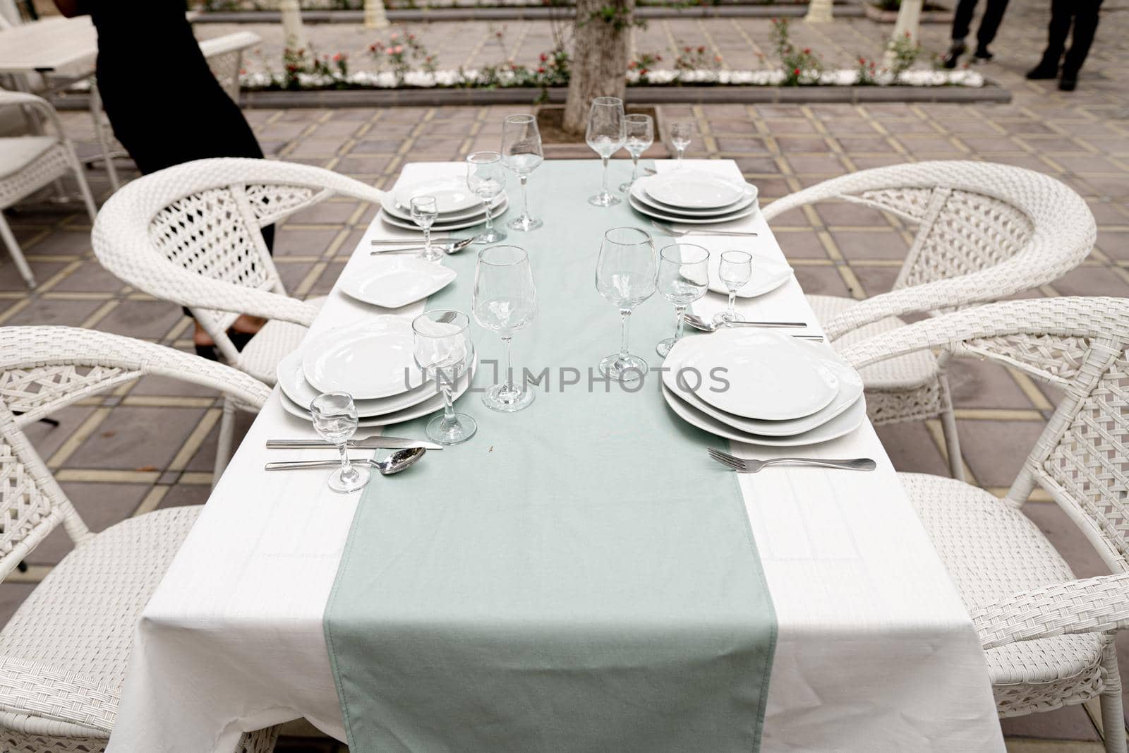 Glasses, fork, knife served for dinner in a restaurant with a cozy interior