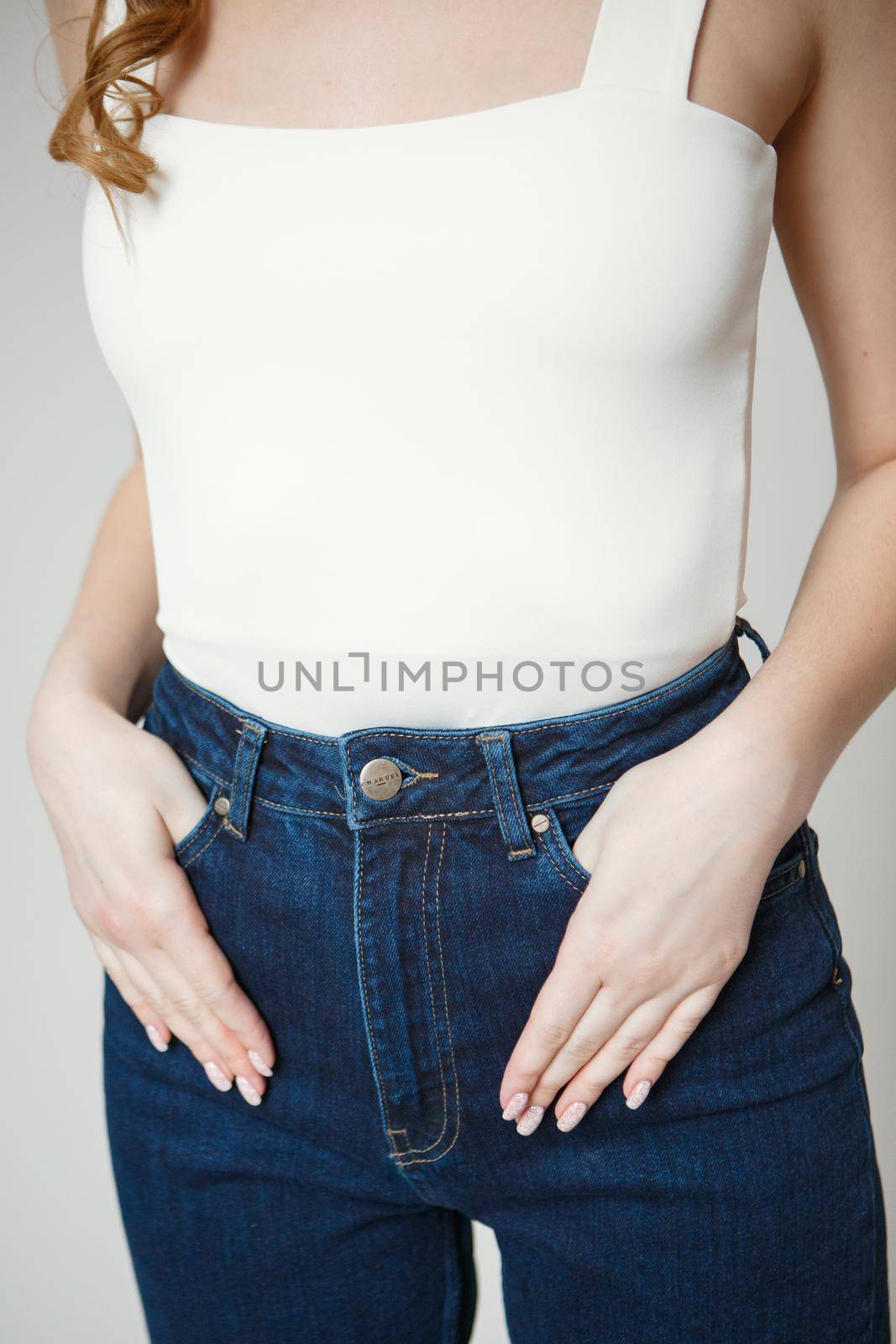 Legs in jeans to beautiful girl. Isolated on background