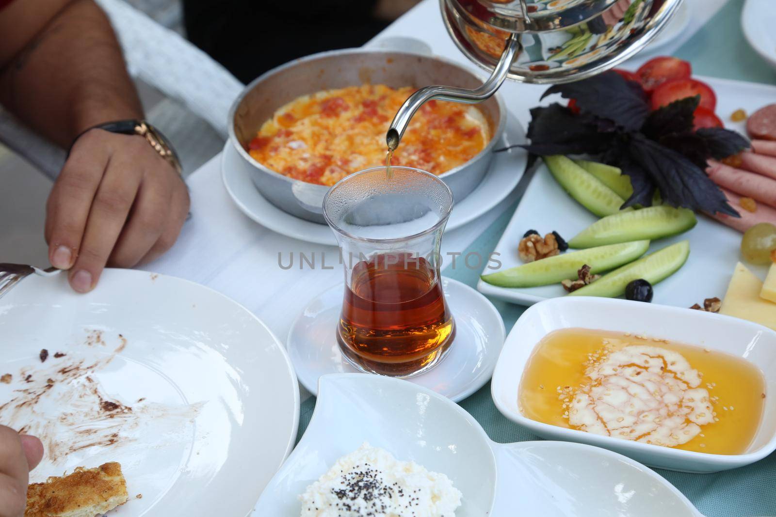 Organic, fresh traditional turkish village breakfast on wooden table with copper egg pan