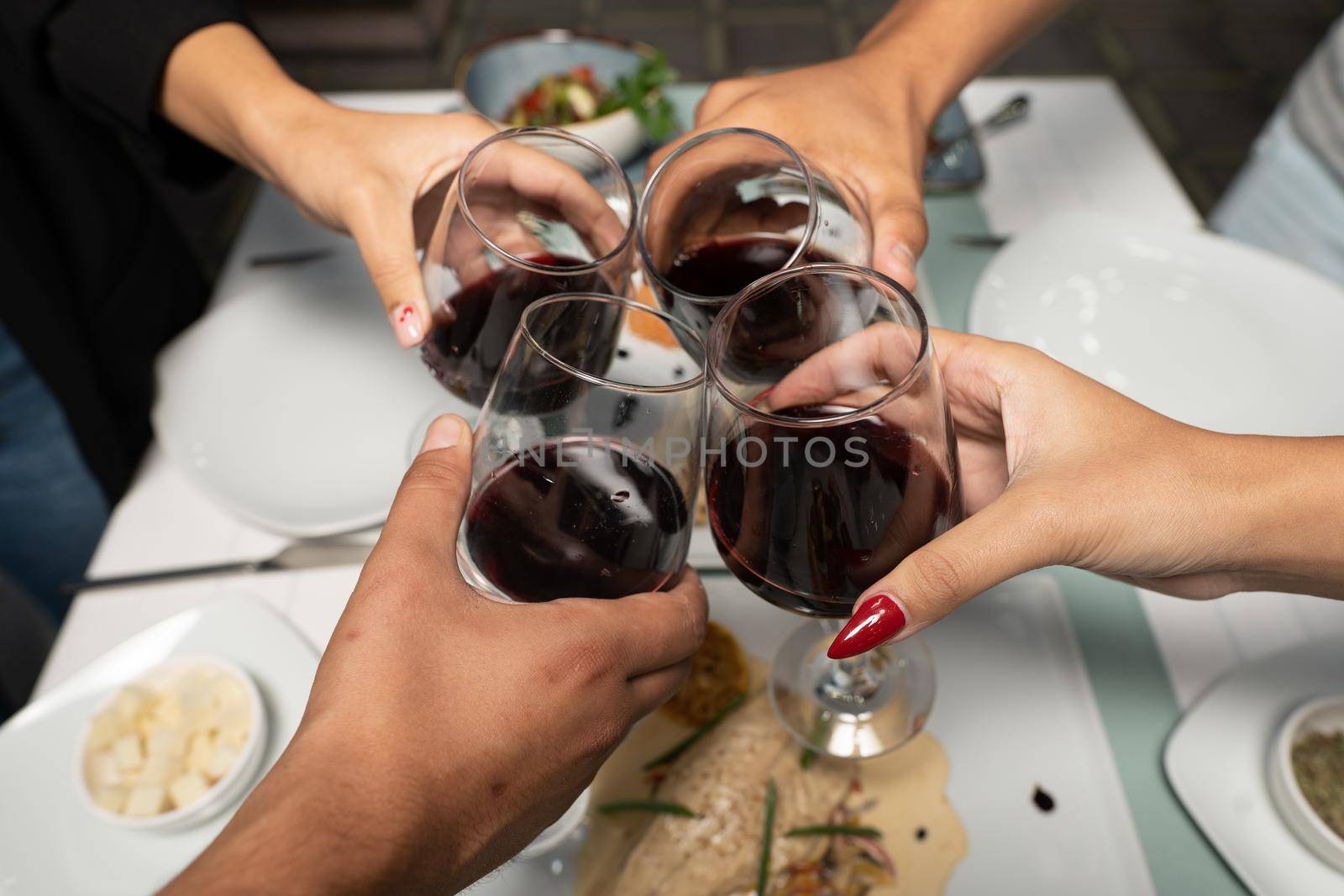 Top view shot of group of people toasting with wine glasses, Summer holiday party