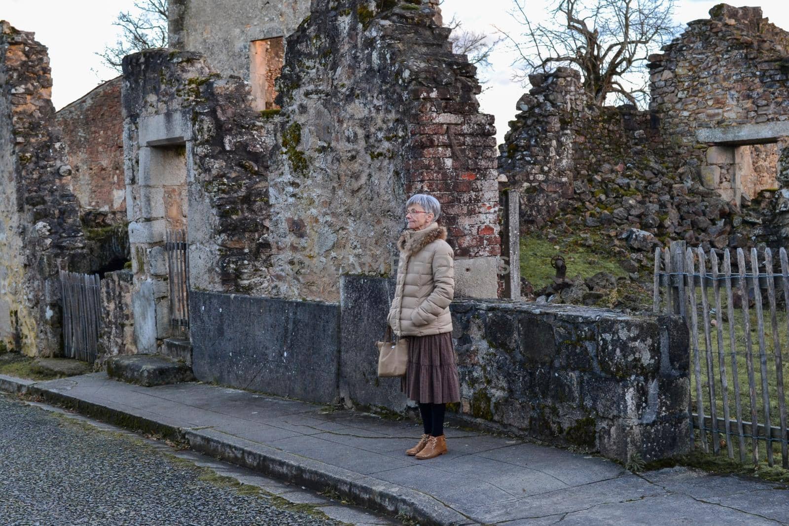 A woman near destroyed building during World War 2 in Oradour sur Glane France