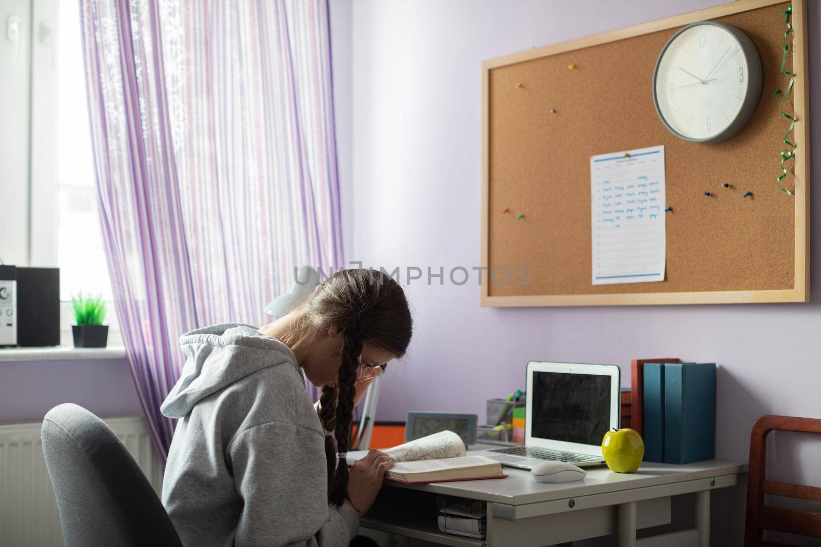 Knowledge gained through reading books. A gifted student. A young girl with braids.