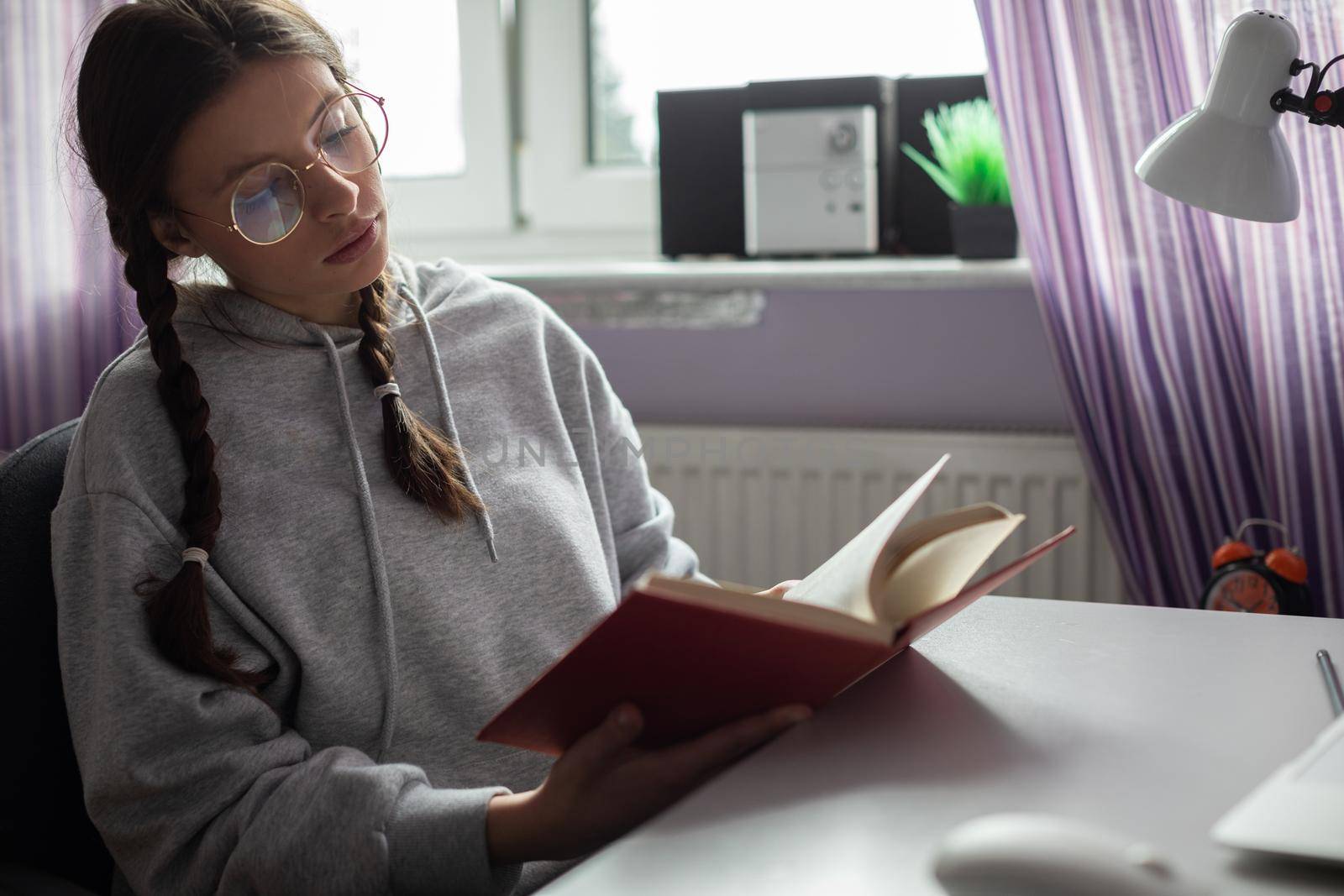 Knowledge gained through reading books. A gifted student. A young girl with braids.