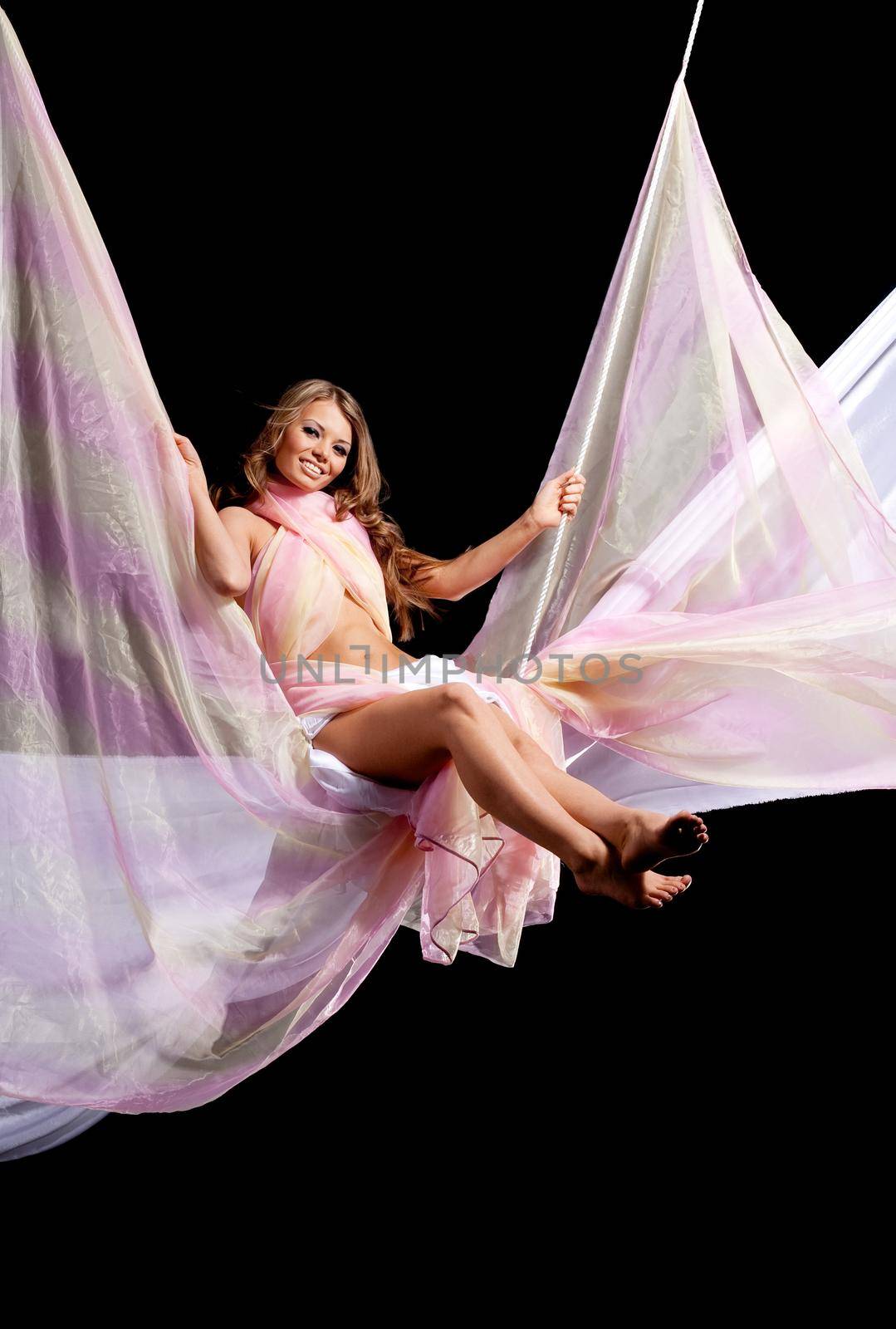 Girl fly on rope swing with color textile