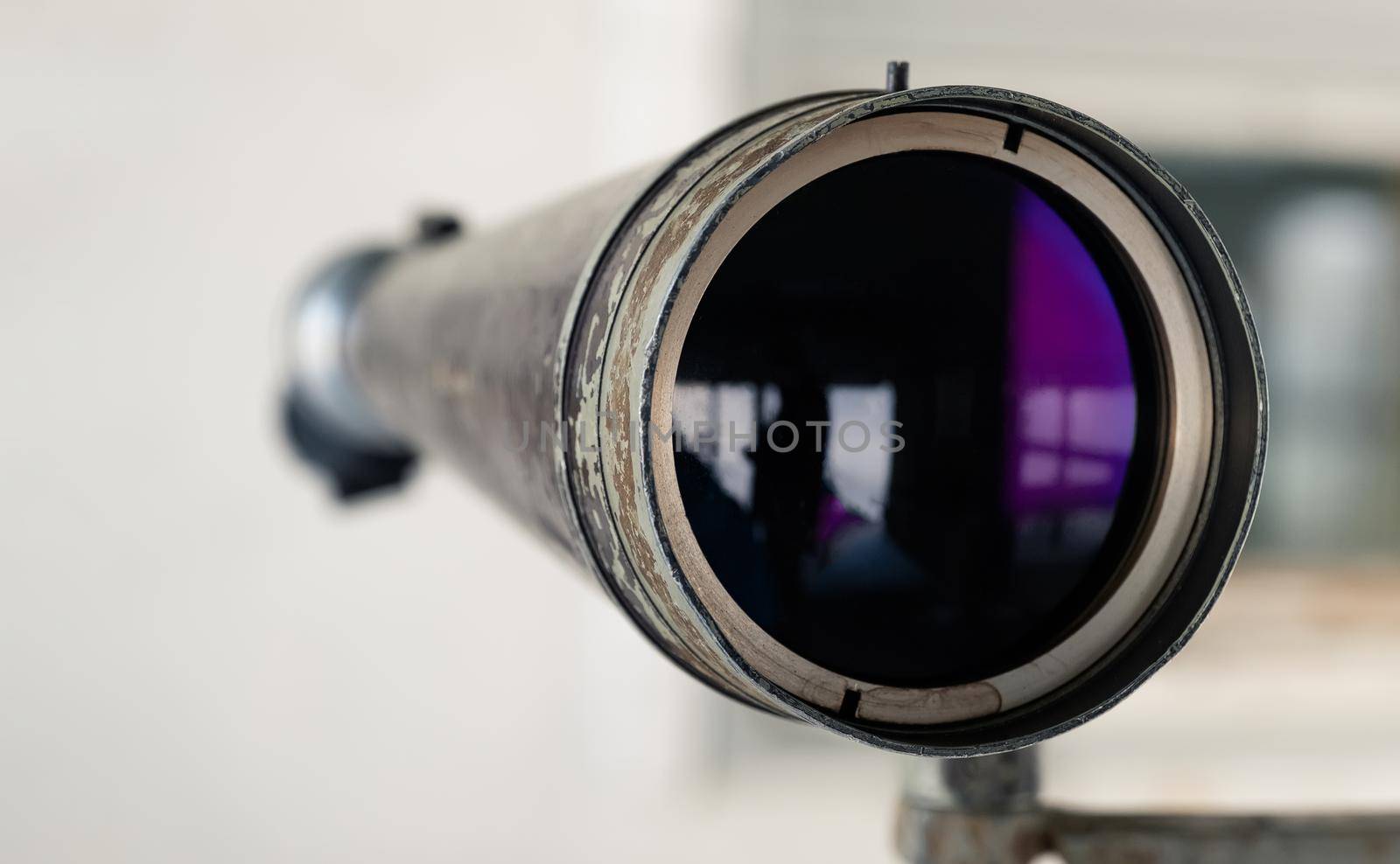Spyglass in the shooting range to watch the target hit. The shooting range instructor looks at the target through a telescope. Optical tube for monitoring and monitoring training in the shooting range