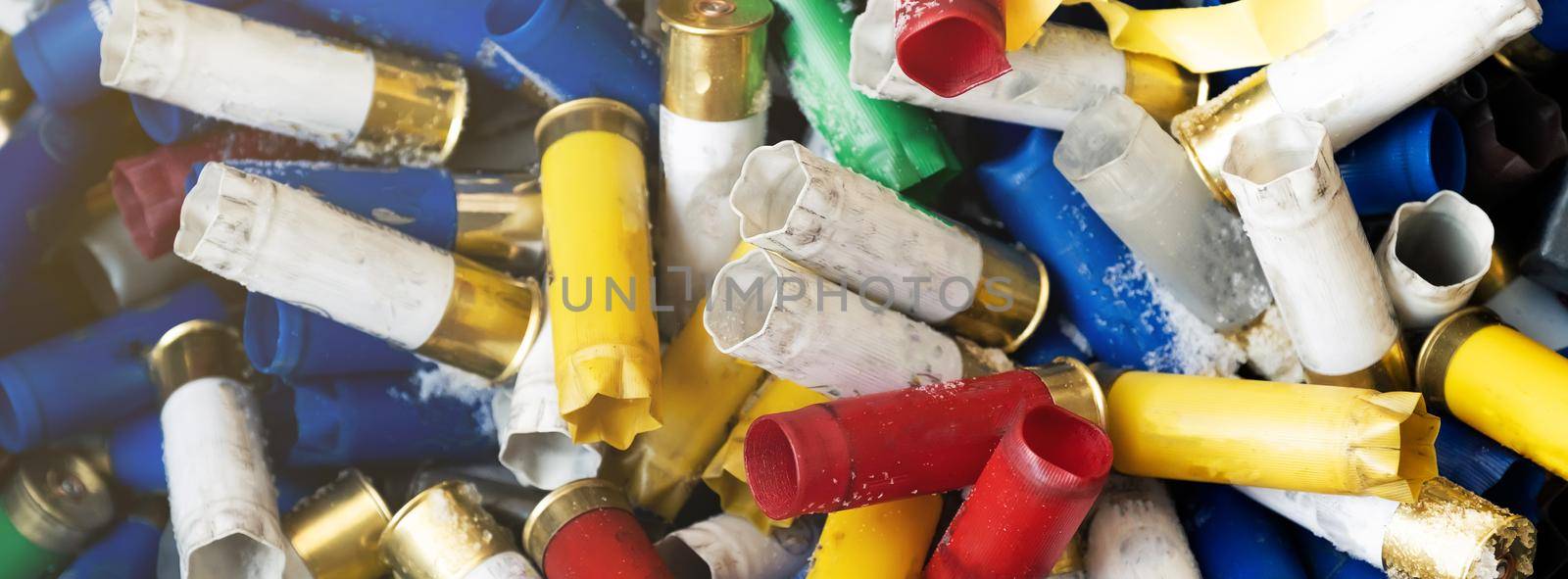 Hunting blank cartridges of 12 gauge are large quantities. Many shotgun cartridges in different colors with empty cartridges can be used as a textured background