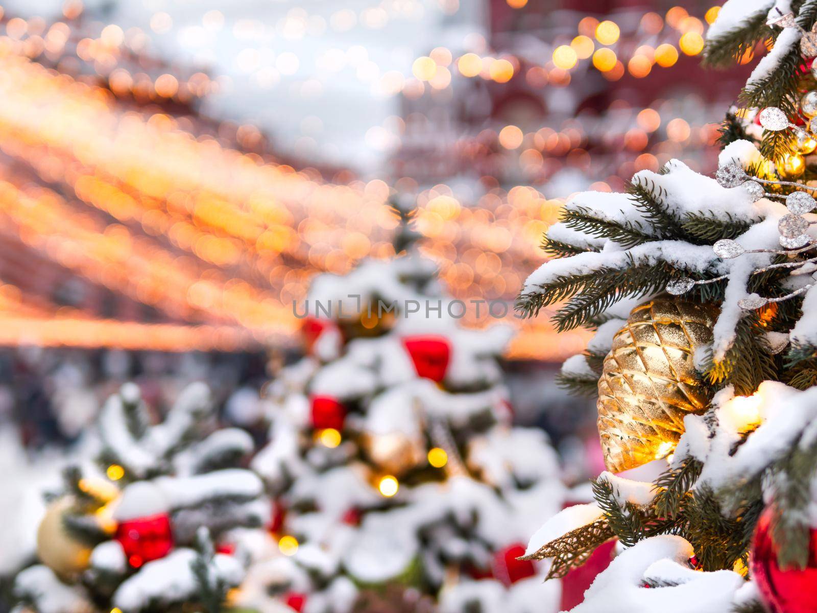 Christmas tree with colorful outdoor decorations. Fir tree decorated with light bulbs for New Year celebration. Moscow, Russia.