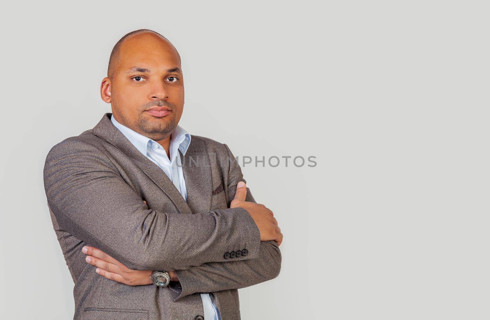 Attractive african american young man guy crossed his arms over his chest. Black man meditating, pondering an idea, decision or concept