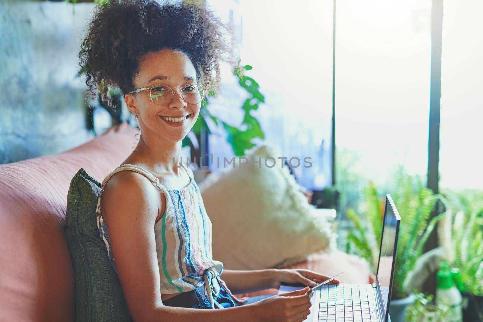 Shot of a beautiful African woman doing online payment