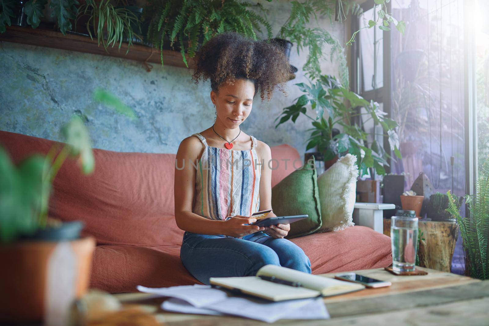 Shot of a beautiful African woman working from home