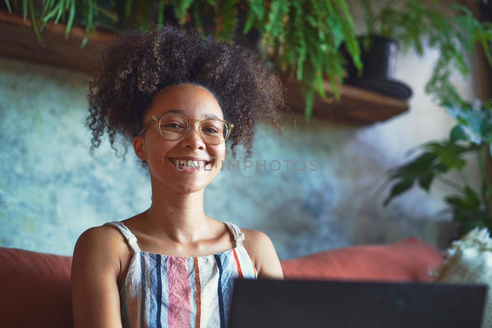 Attractive African woman working from her living room