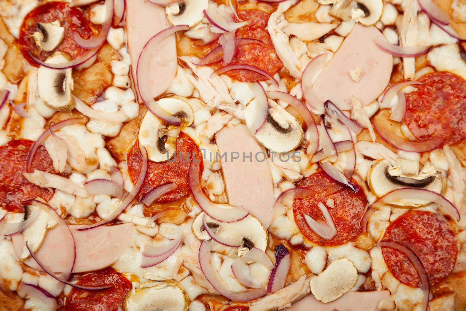 Pizza texture BBQ sauce, mozzarella cheese, ham, pepperoni, smoked chicken, mushrooms, red onion. Close-up. Restaurant flyer and poster.