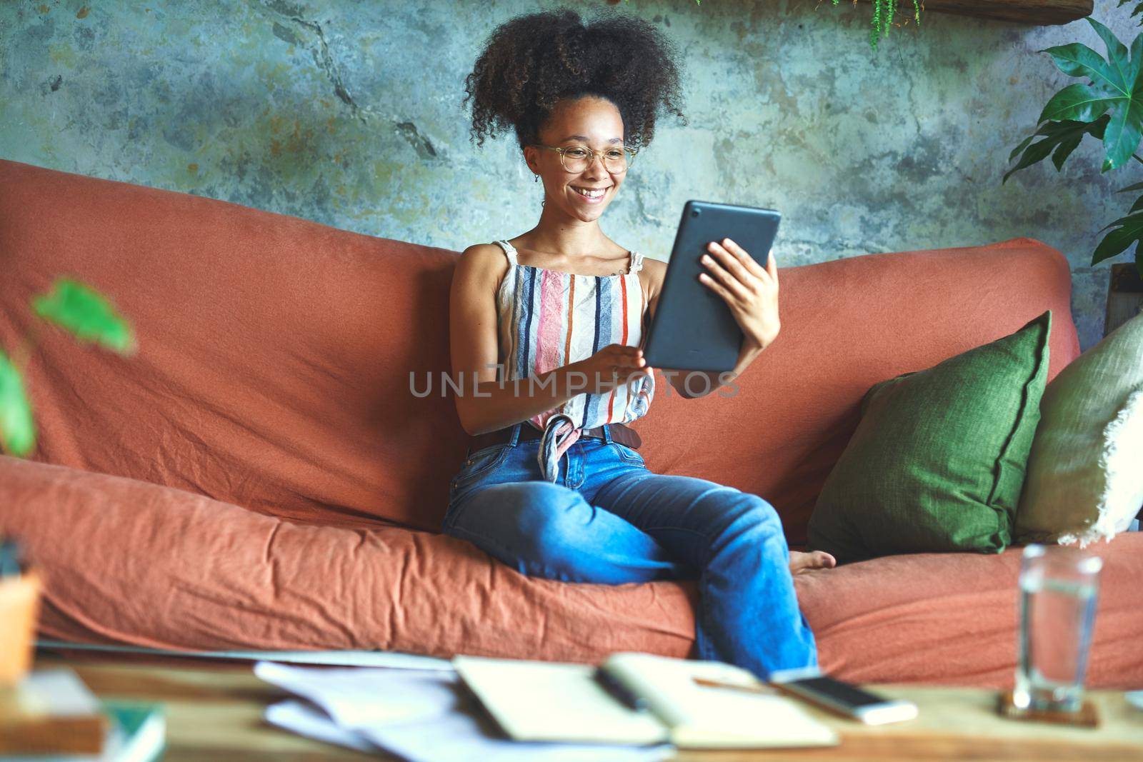 Shot of a beautiful young woman using a digital tablet for a video call in her living room