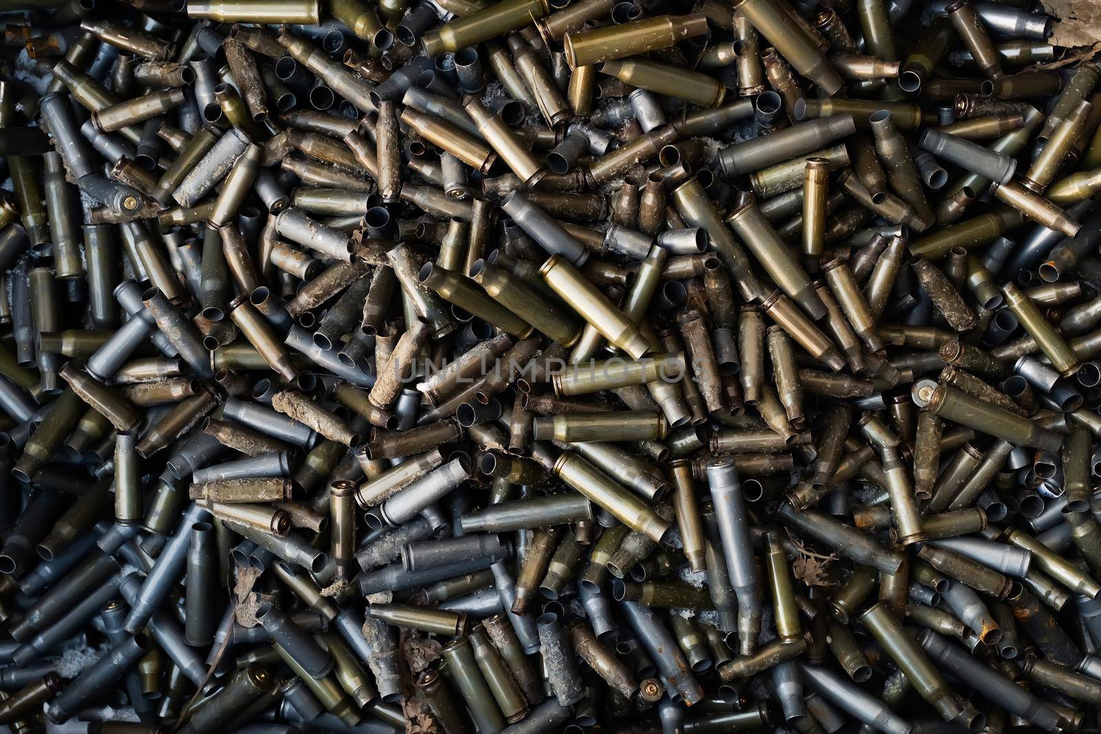 Empty carbine or rifle cartridges. A large number of cases. Background of brass ammunition cartridges to illustrate armed conflict, war or shooting