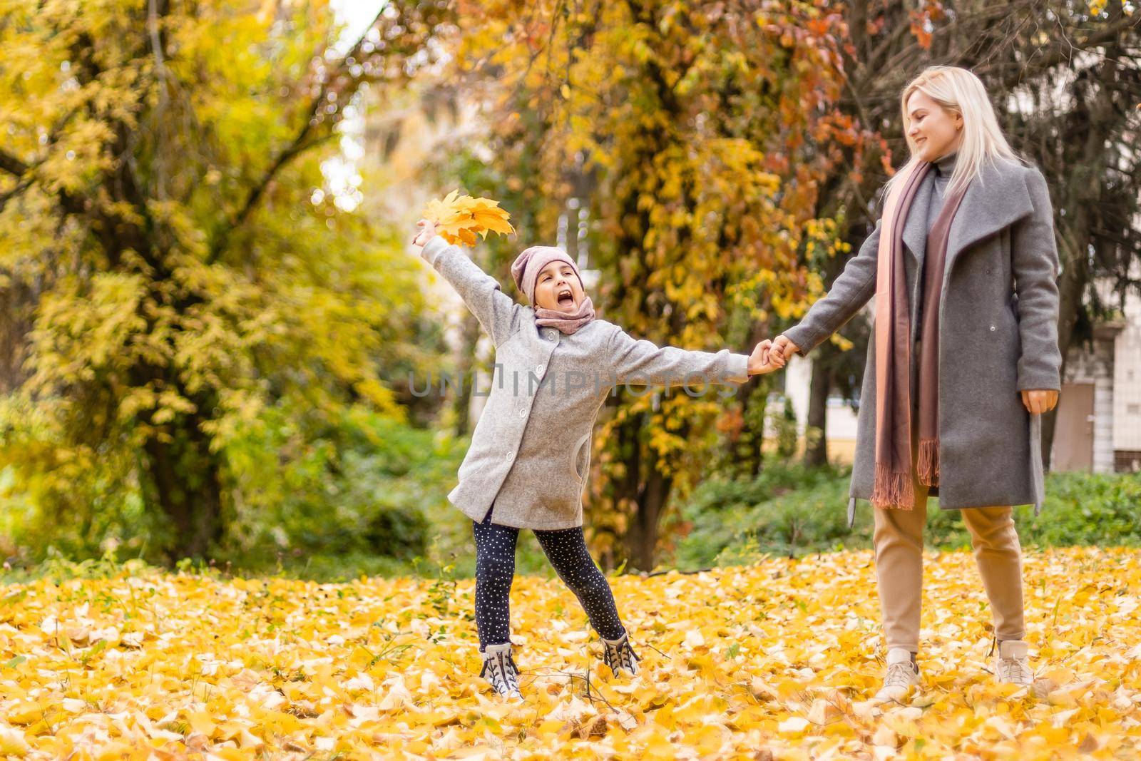 Mother and daughter in autumn yellow park by Andelov13