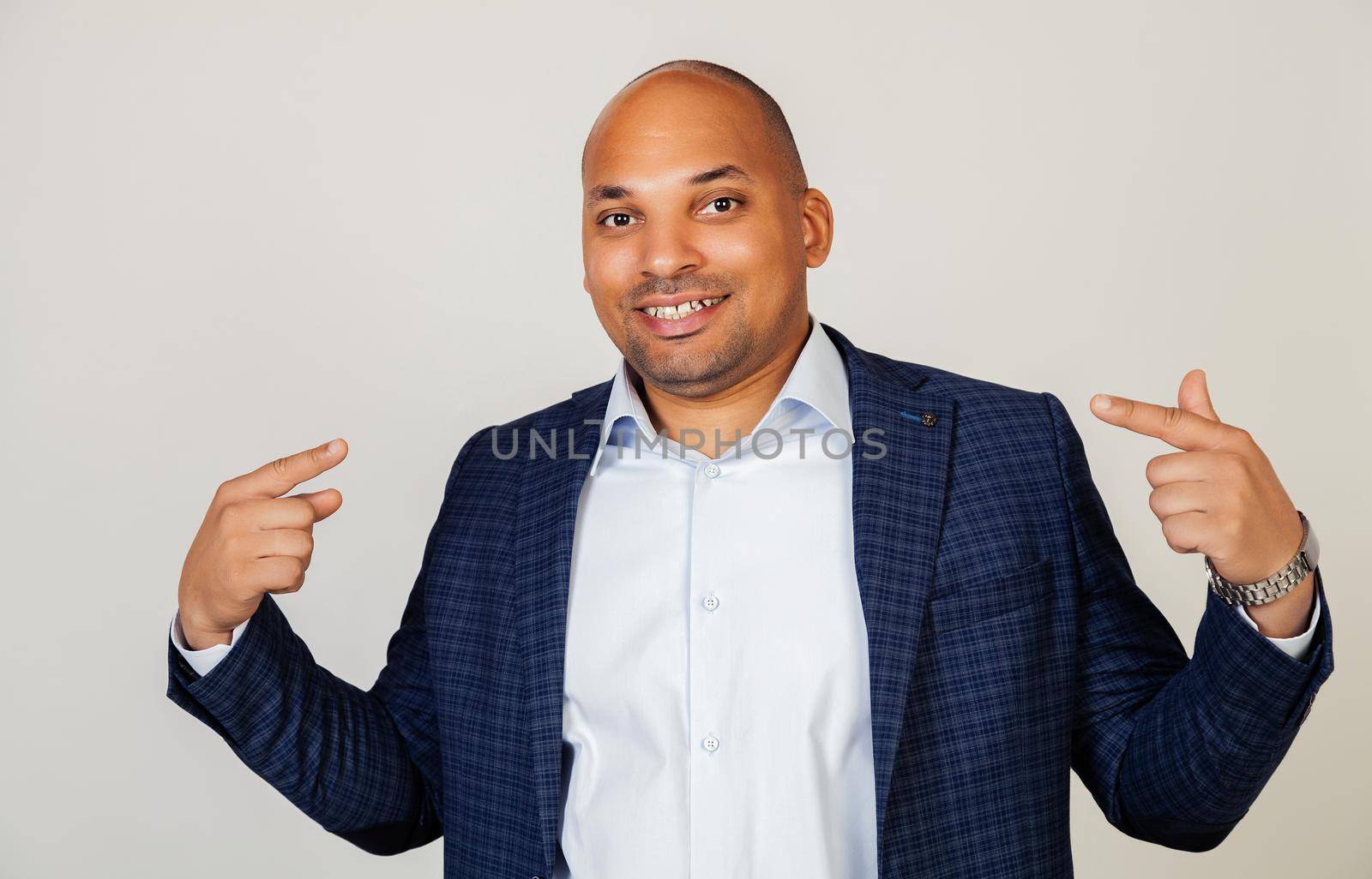 Young African American man smiling confidently showing and pointing with fingers, teeth and mouth. Health concept. by ViShark