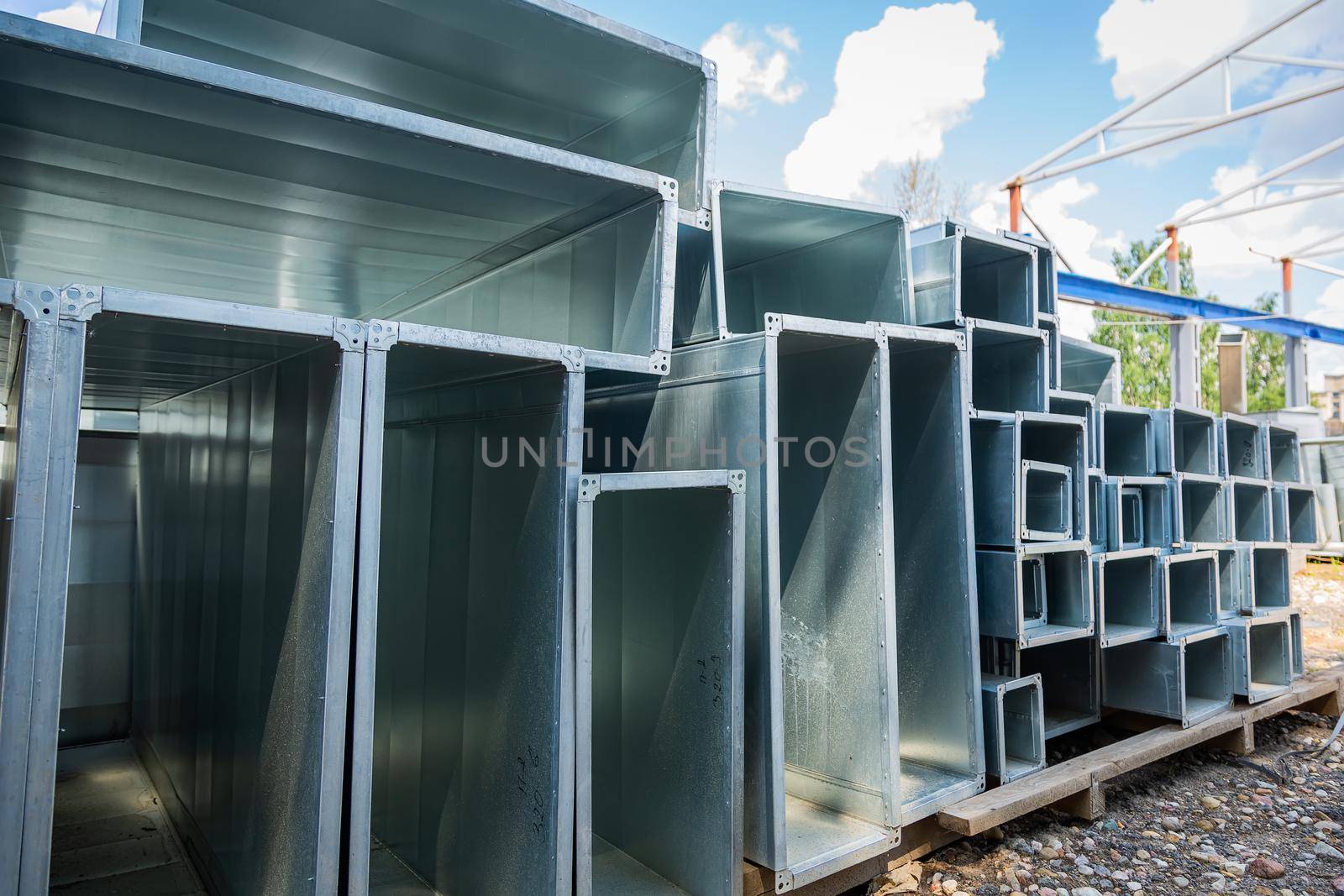 Ventilation pipes are square and rectangular. Steel pipes, parts for the construction of air ducts for an industrial air conditioning system in a warehouse. Industrial ventilation equipment